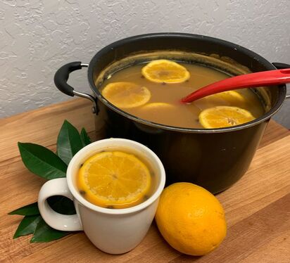 Hot orange punch in mug and pot